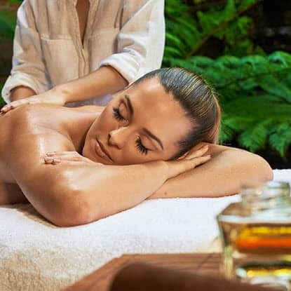 Relax - Unwind at Zen'd Out Process, Denver A woman lying face down on a massage table receiving a treatment