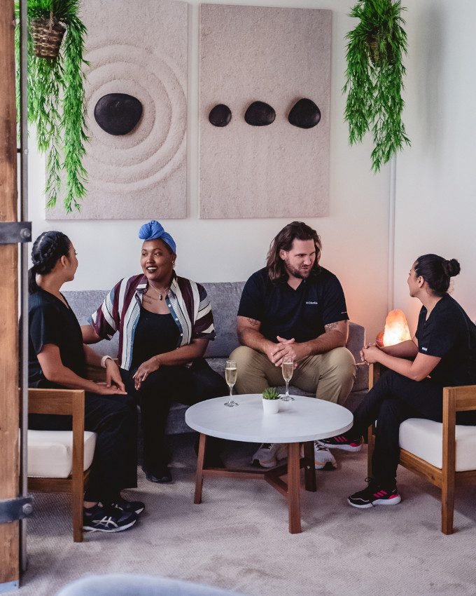 Zen’d Out Couples Massage Spa at Zen'd Out Massage Spa Denver A group of massage therapists sitting while chatting with each other