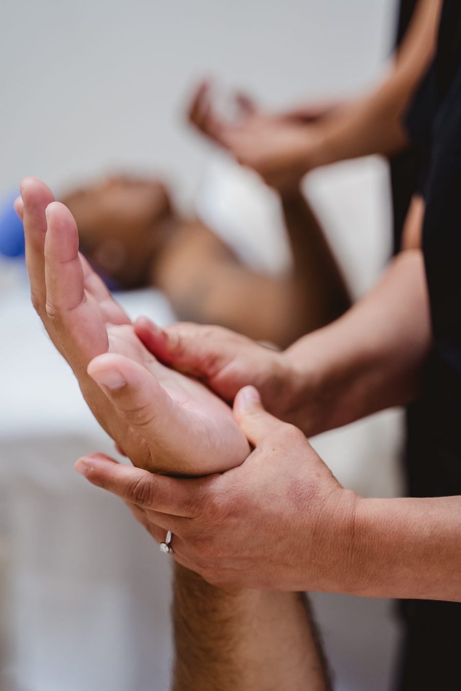 A therapist performing a reflexology massage on a client.