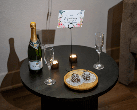Gift card, champagne and house-made chocolates set out in a Zen’d Out couples suite