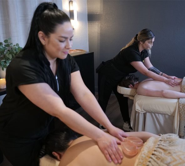 zendoutexperi Two therapists provide a side-by-side couple's massage using heart stones.