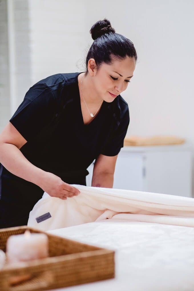 Sport-massage-therapy-at-Zend-Out-Massage-Spa-opt A massage therapist carefully preparing a treatment table