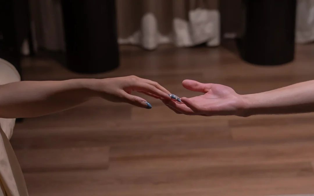 Close-up of a couple holding hands in a luxury spa, highlighting relaxation and connection.