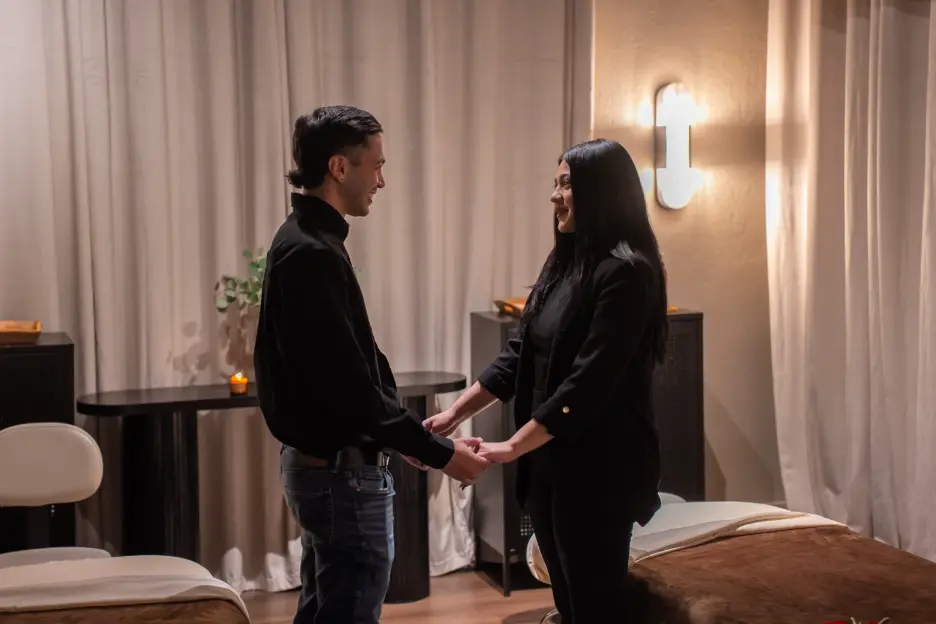 Couple holding hands at a luxury massage spa