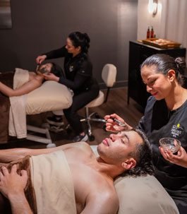 couple-massagn Two people getting a couples massage side-by-side.