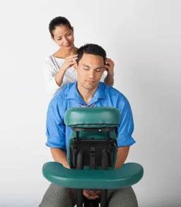 A man getting an in-office chair massage.