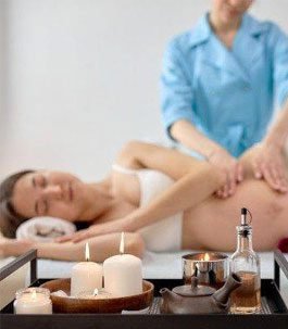 A pregnant woman relaxing while getting a prenatal massage
